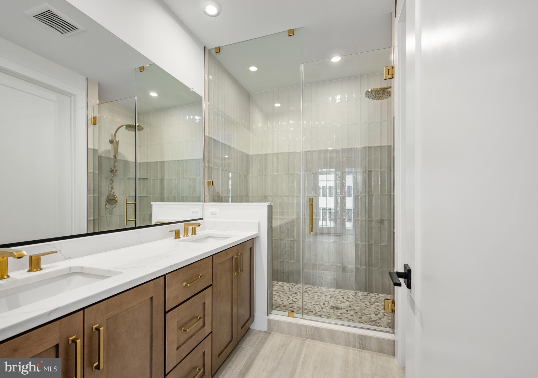 8610 Erdem Place Chevy Chase, MD 20815 - Photo 4 of 21 a bathroom with a shower sink and mirror