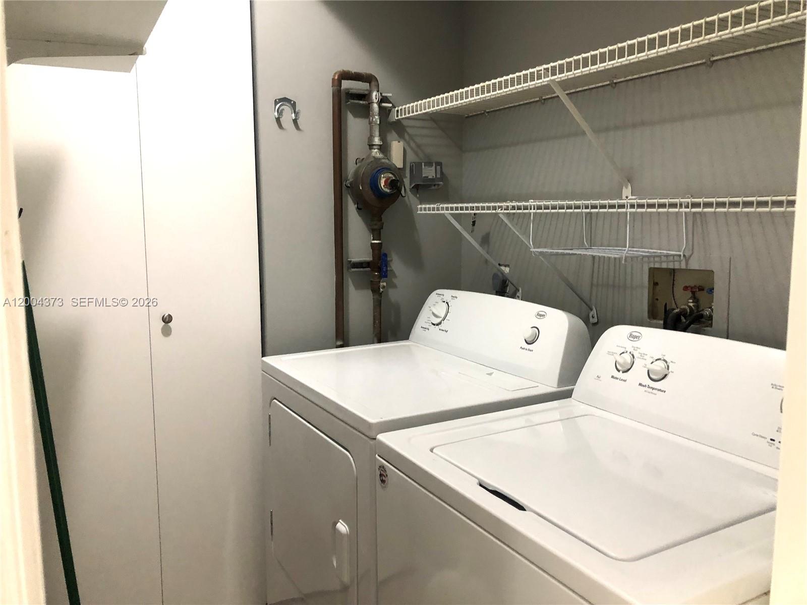 8761 Wiles Road, Unit 306 Coral Springs, FL 33067 - Photo 10 of 26 a utility room with dryer and washer