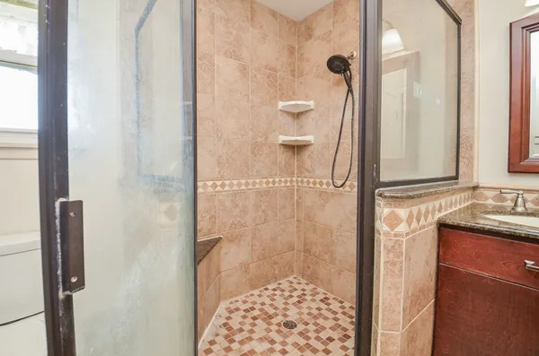 a bathroom with a shower and a sink