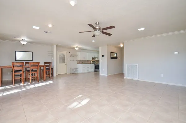 a view of kitchen with furniture and a refrigerator