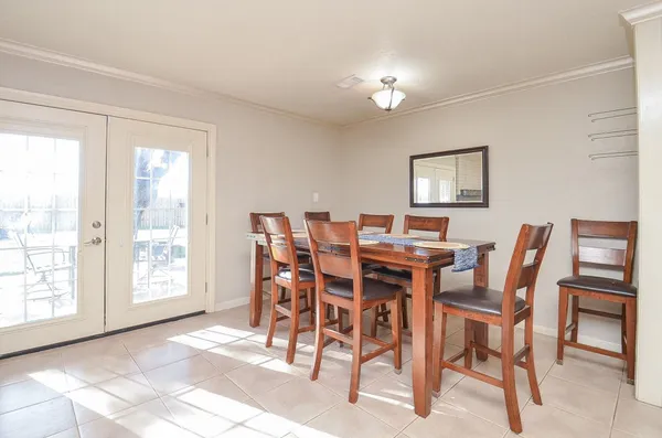 a view of a dining room with furniture and chandelier