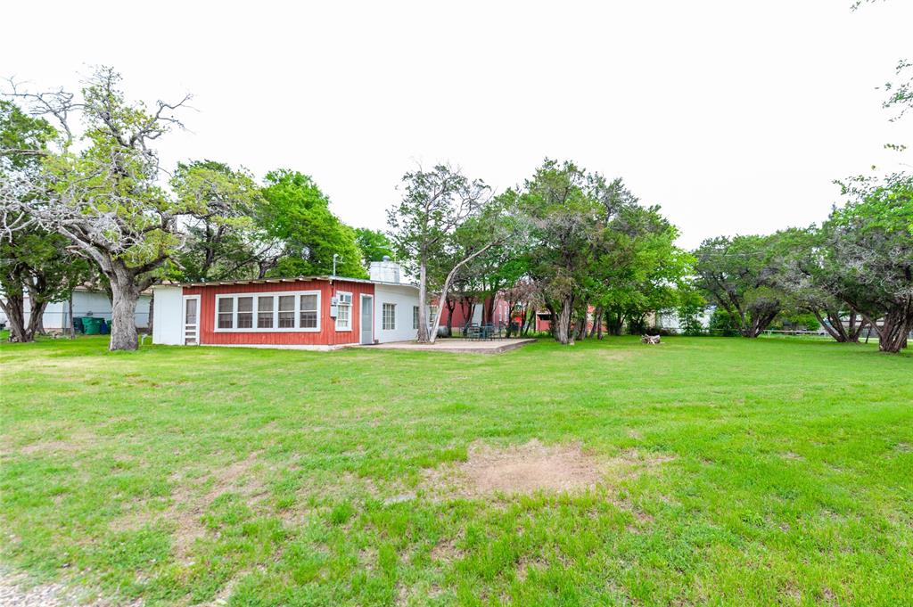 137 Center Loop Whitney, TX 76692 - Photo 11 of 33 a view of a house with a yard