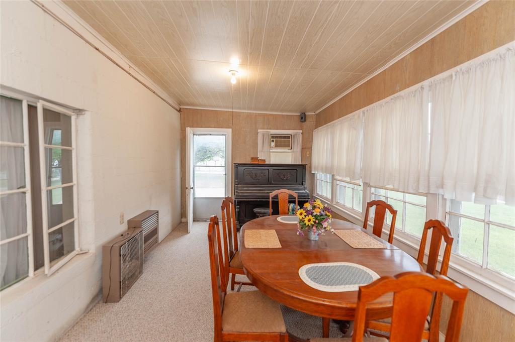 137 Center Loop Whitney, TX 76692 - Photo 17 of 33 a dining room with furniture and a large window