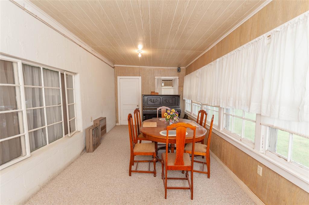 137 Center Loop Whitney, TX 76692 - Photo 22 of 33 a dining room with furniture and a large window