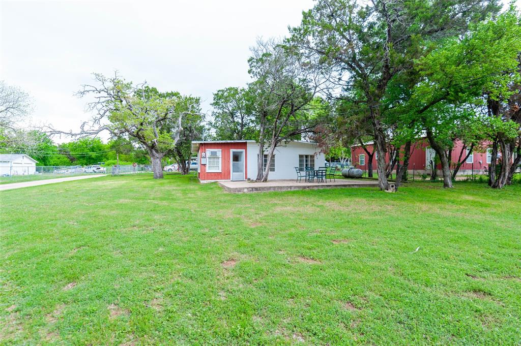 137 Center Loop Whitney, TX 76692 - Photo 3 of 33 a view of a house with a big yard and large trees