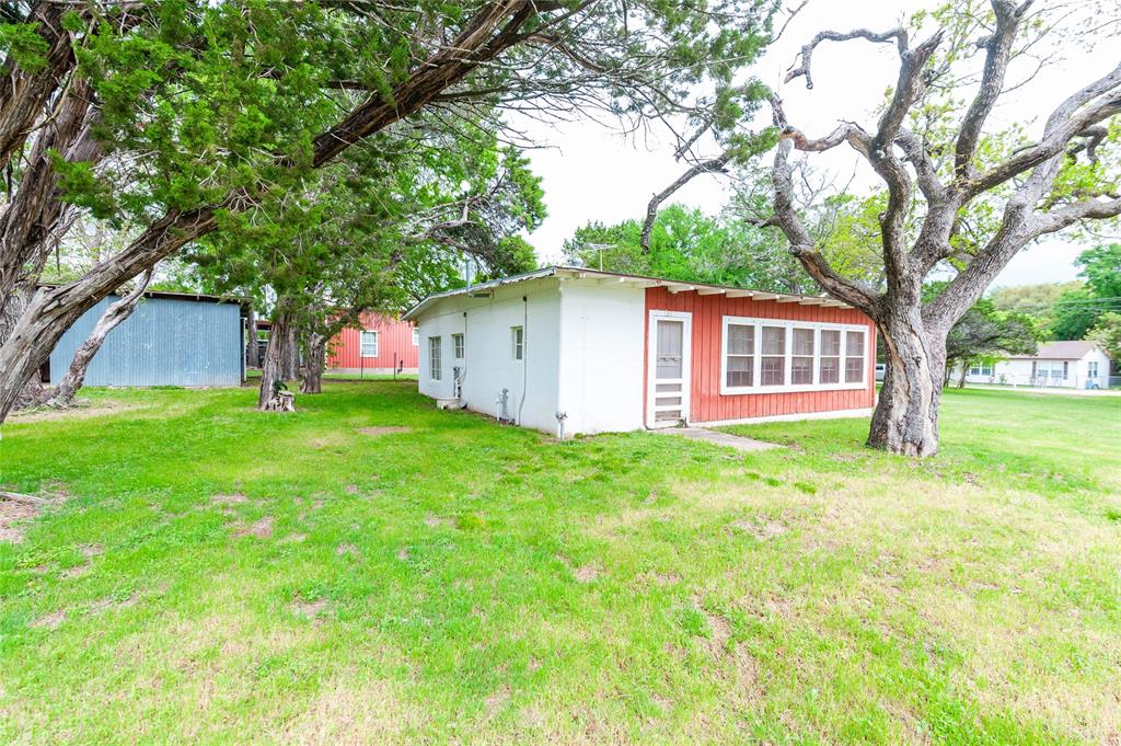 137 Center Loop Whitney, TX 76692 - Photo 31 of 33 a view of a house with backyard and a tree