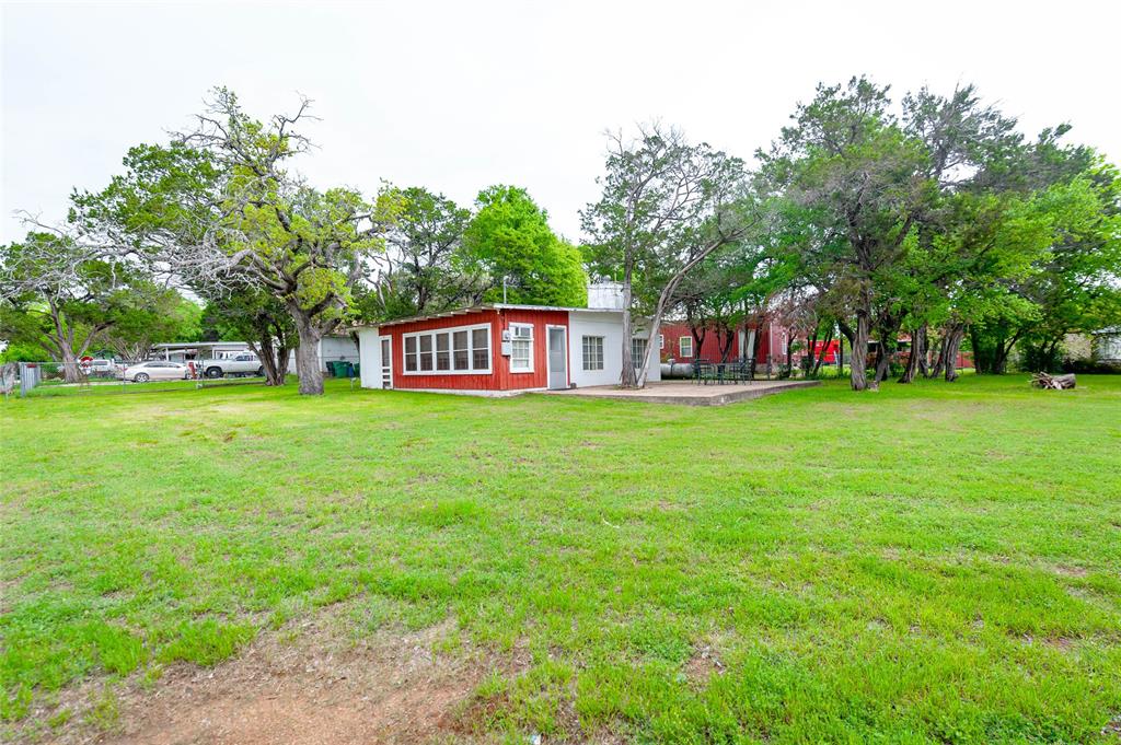 137 Center Loop Whitney, TX 76692 - Photo 4 of 33 a view of a house with a big yard and large trees