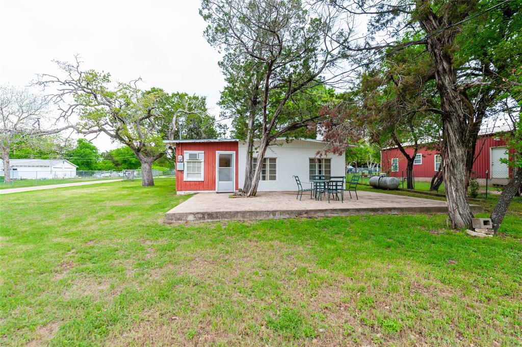 137 Center Loop Whitney, TX 76692 - Photo 7 of 33 a front view of a house with garden