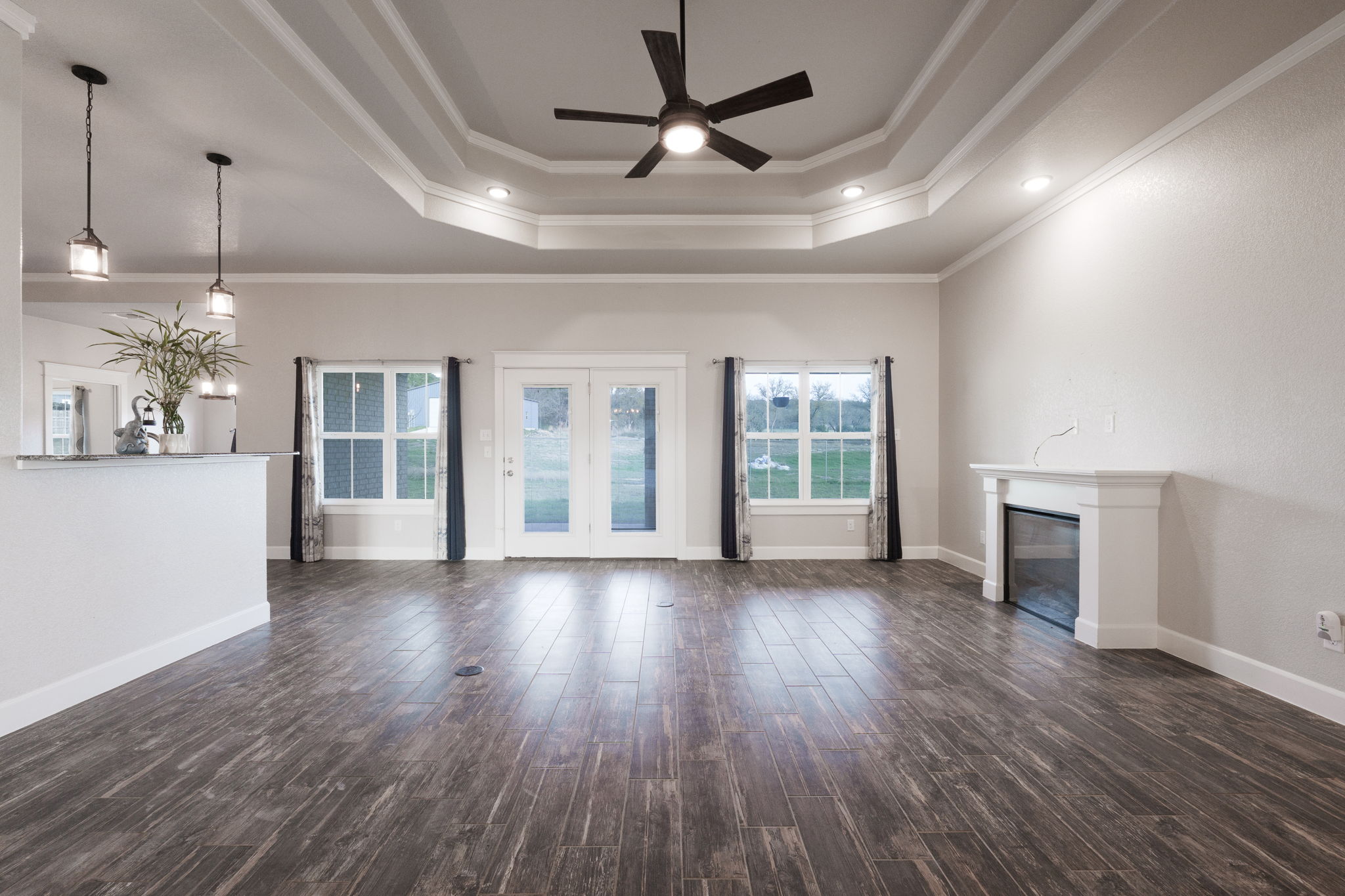 2662 Snow Road Kempner, TX 76539 - Photo 6 of 28 a view of a livingroom with wooden floor a ceiling fan and windows