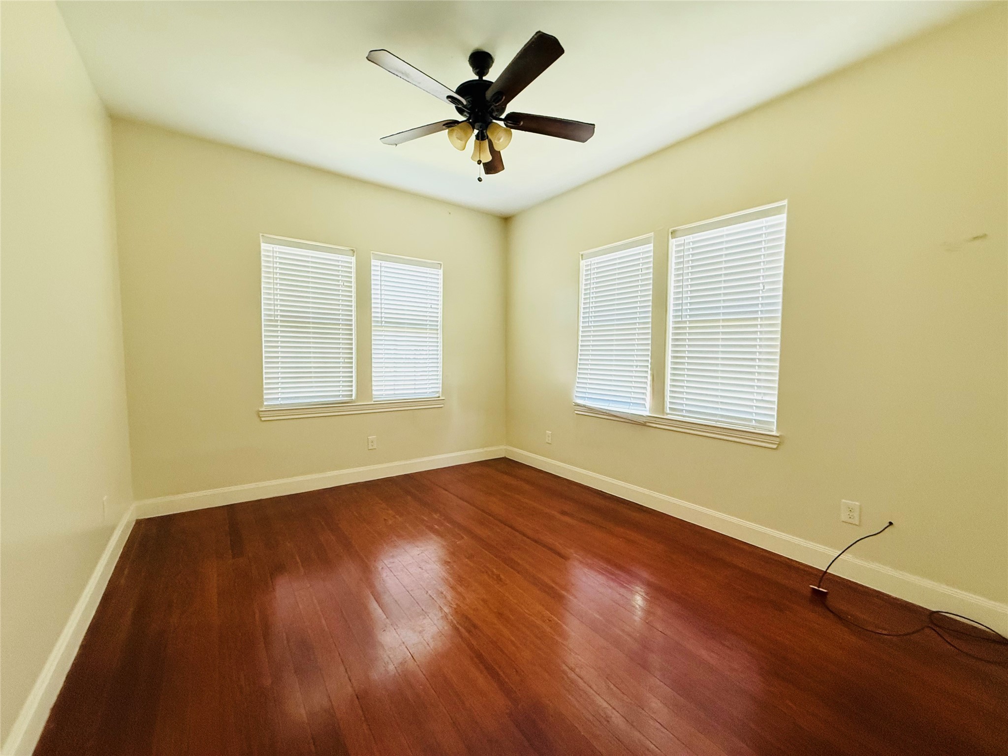 446 Zoe Street Houston, TX 77020 - Photo 12 of 16 a view of room with wooden floor and ceiling fan