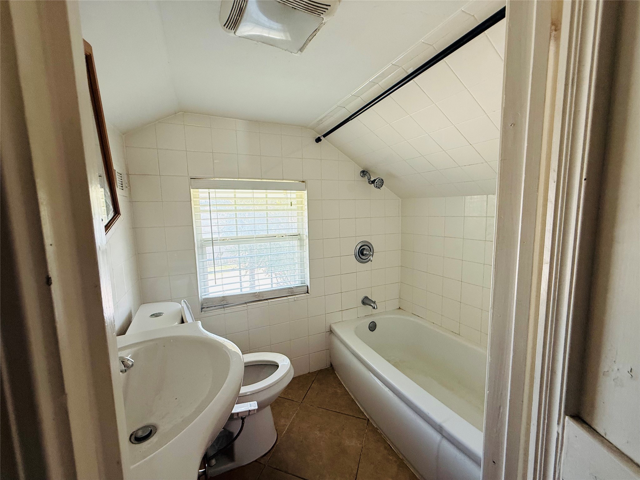 446 Zoe Street Houston, TX 77020 - Photo 16 of 16 a bathroom with a tub a sink and a window