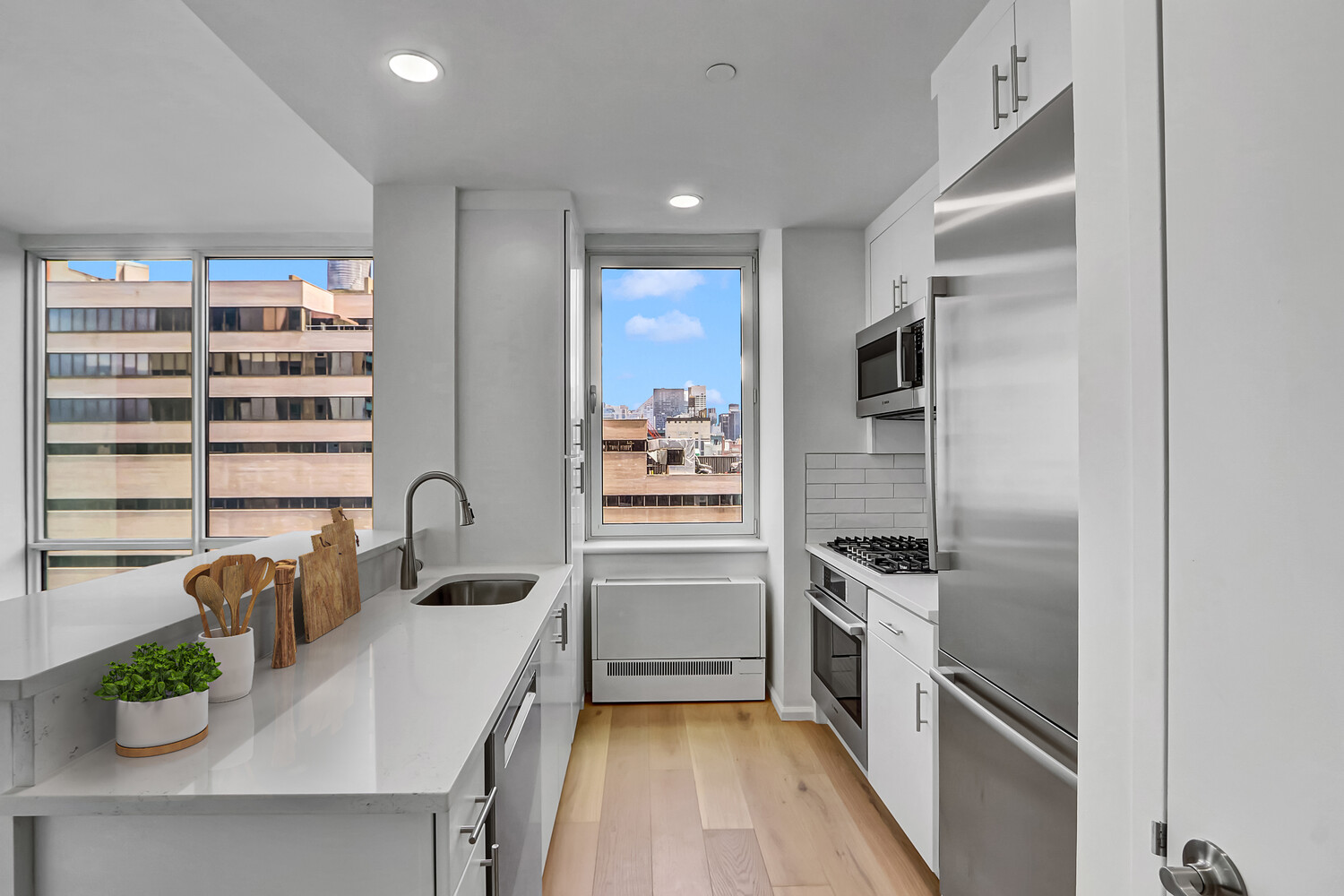 635 West 42nd Street, Unit 7A Manhattan, NY 10036 - Photo 15 of 28 a kitchen with a refrigerator and a sink