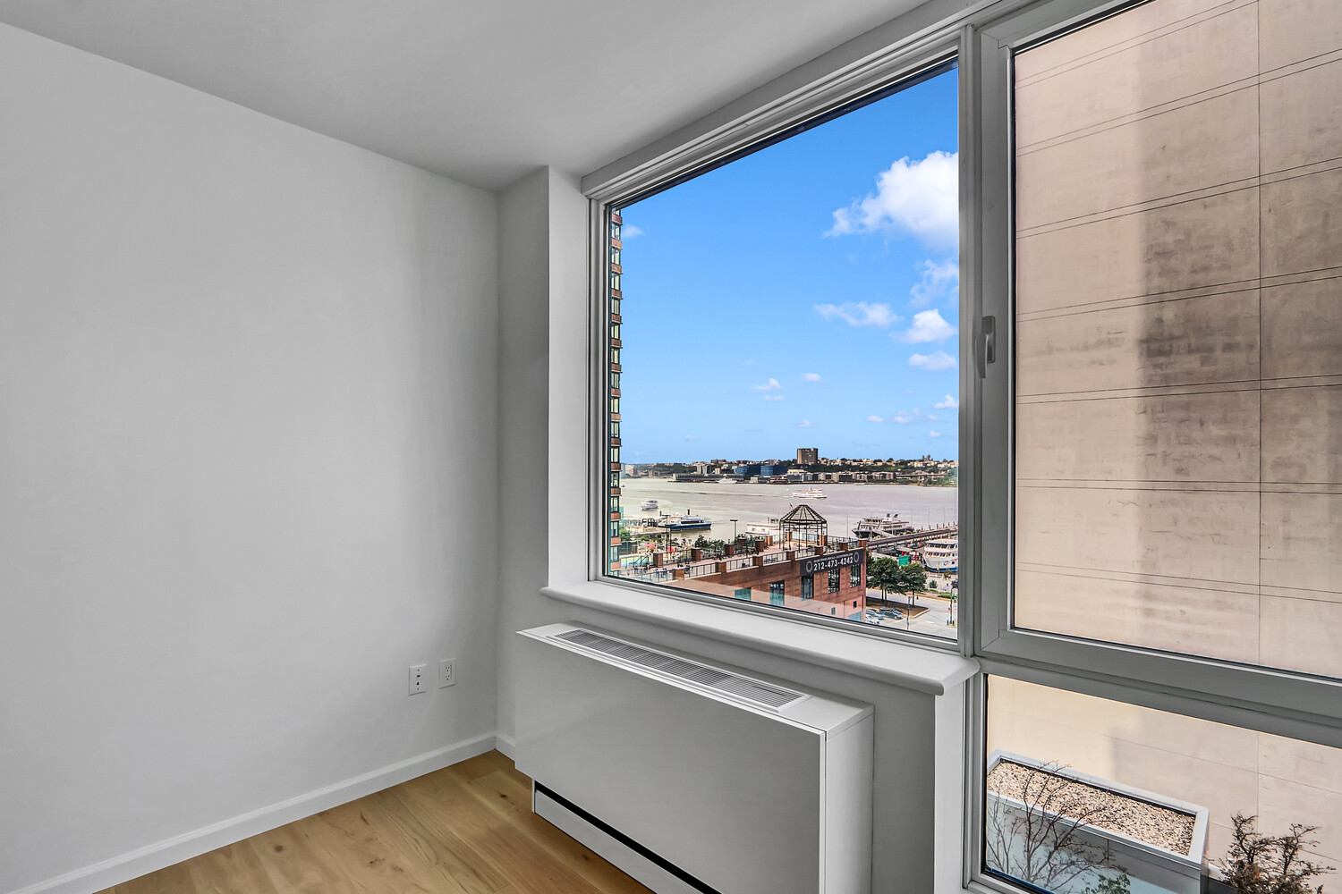 635 West 42nd Street, Unit 7A Manhattan, NY 10036 - Photo 25 of 28 a view of an empty room and window