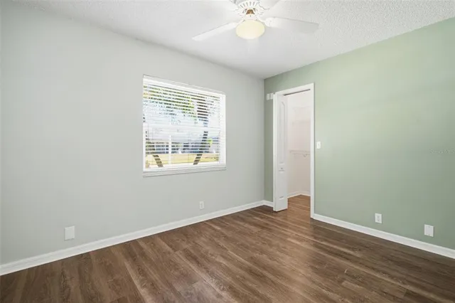 a view of an empty room with wooden floor