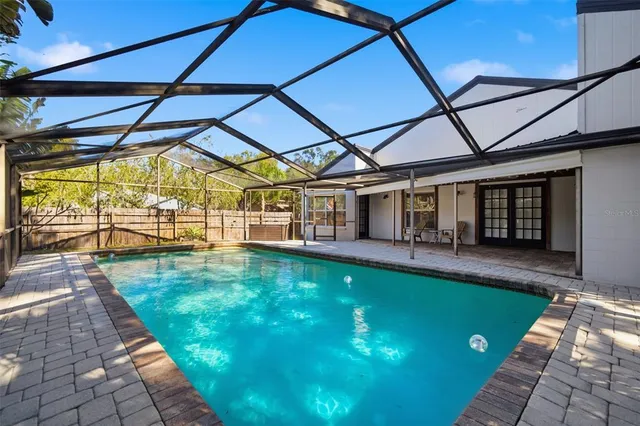 a large kitchen with stainless steel appliances kitchen island granite countertop a refrigerator oven a sink and a large window