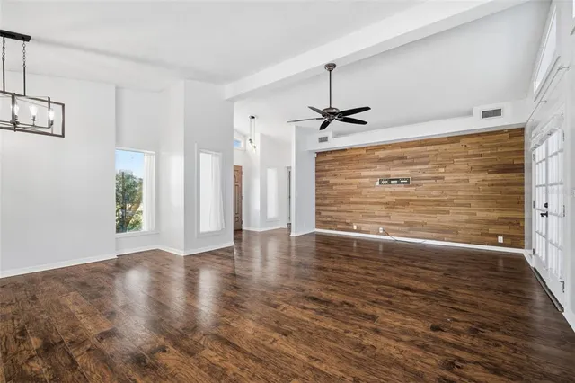a large kitchen with kitchen island a stove a sink a center island and wooden floor