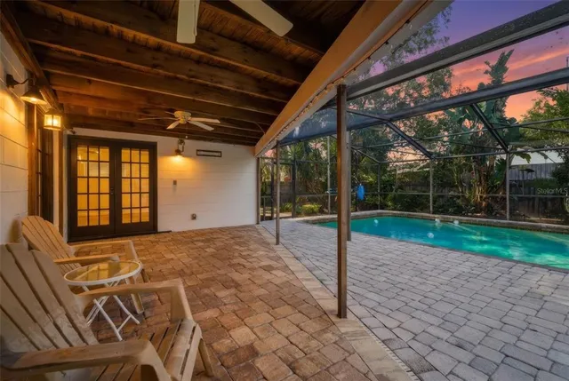 a view of a house with a yard and basketball court