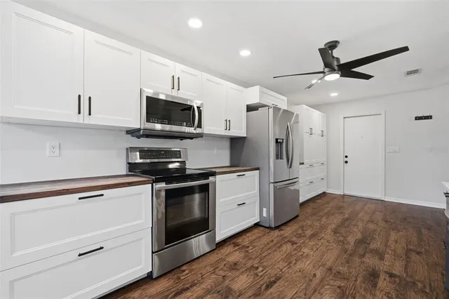a view of a patio with a table and chairs next to a yard