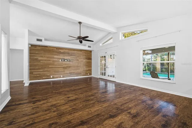 a view of empty room with wooden floor