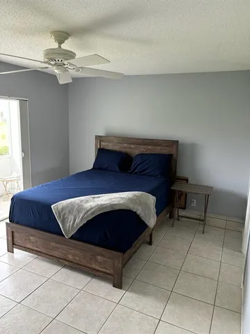a living room with a couch and chandelier