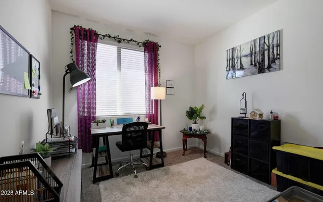 a bedroom with a bed window and flat screen tv