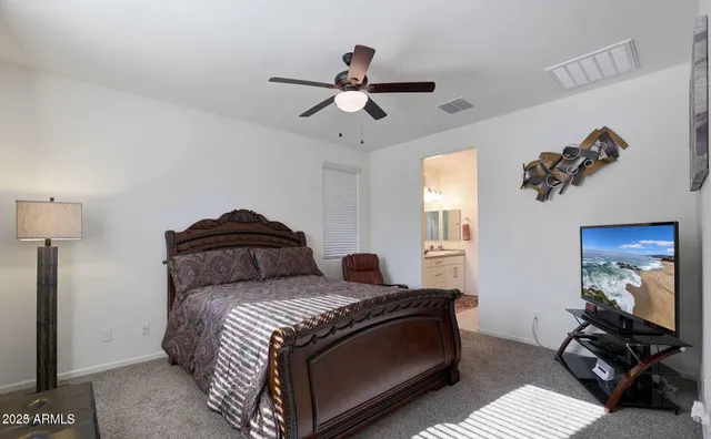 a large kitchen with stainless steel appliances kitchen island granite countertop a refrigerator and a stove top oven with wooden floor