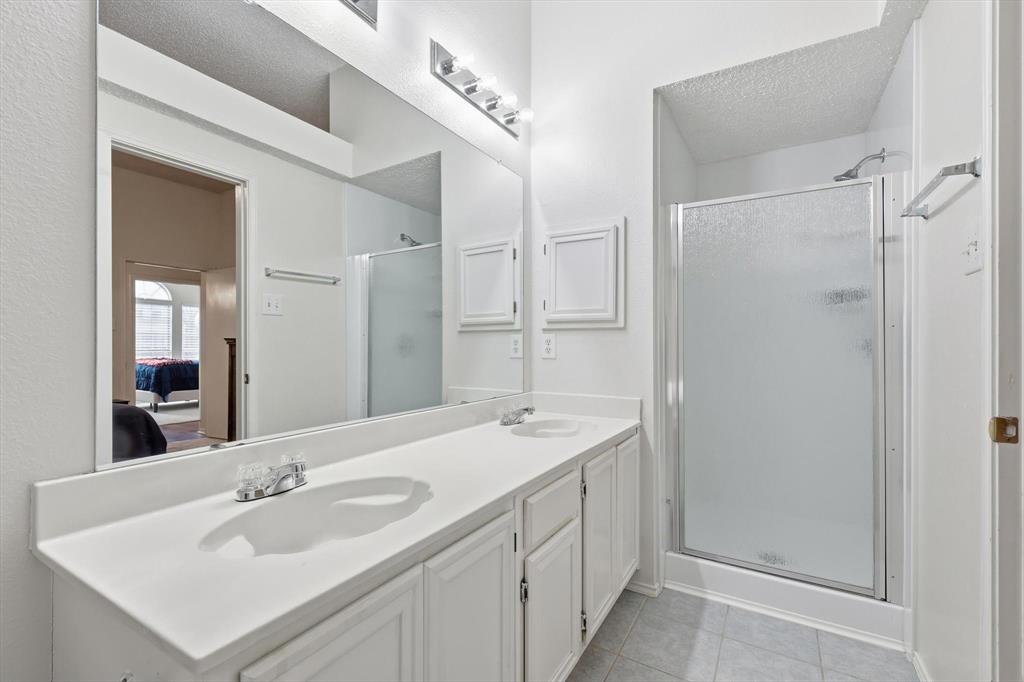 705 Squire Court Allen, TX 75002 - Photo 18 of 27 a bathroom with a sink and a mirror