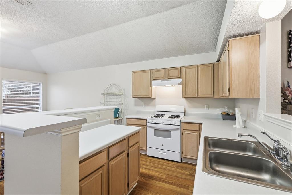 705 Squire Court Allen, TX 75002 - Photo 9 of 27 a kitchen with a sink stove top oven and refrigerator