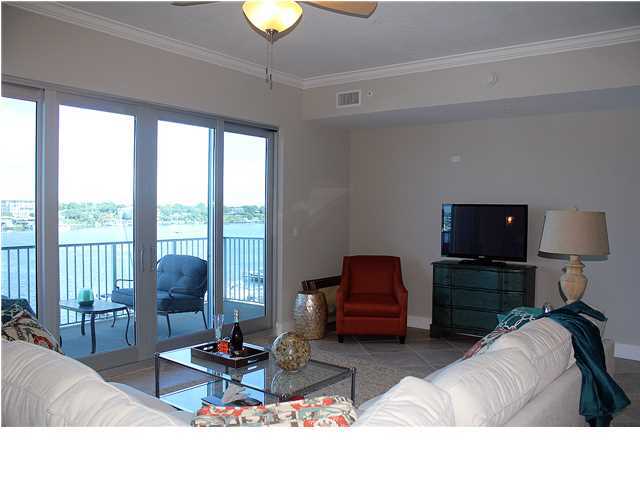 211 Durango Road, Unit 515 Destin, FL 32541 - Photo 12 of 34 a living room with furniture a flat screen tv and floor to ceiling window