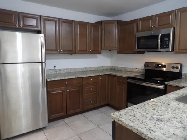 a kitchen with a sink and a refrigerator
