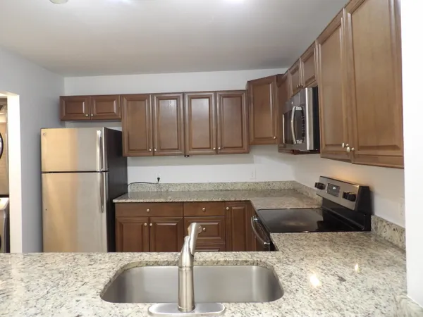 a kitchen with a refrigerator sink and stove