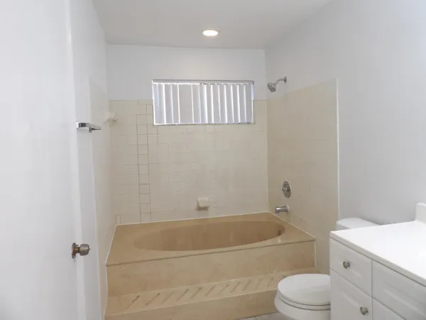 a bathroom with a toilet and a bathtub