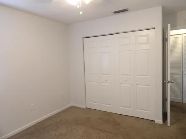 an empty room with closet area