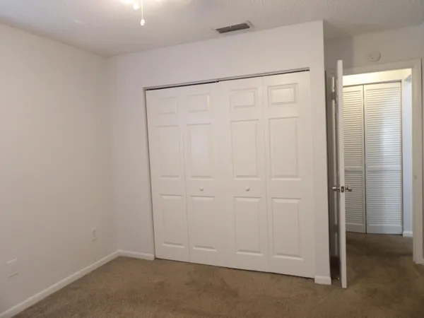 an empty room with closet area