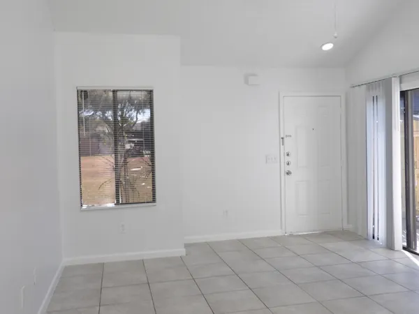 an empty room with windows and closet
