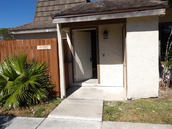 a picture of a door and a car parked in front of a house