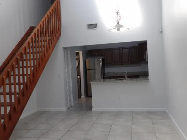 a view of a livingroom with furniture and staircase