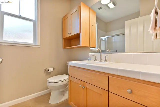 a bathroom that has a glass shower door