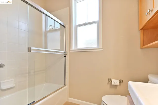 a bathroom with a sink mirror and a shower