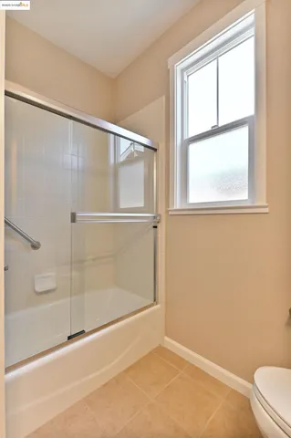 a bathroom with a glass shower door