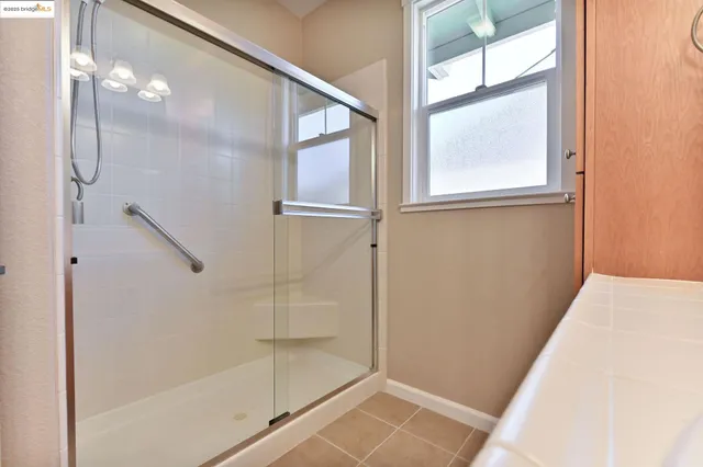 a bedroom with furniture and a large window