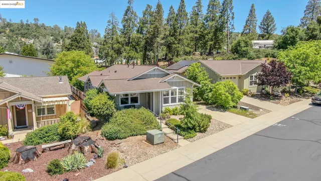 an aerial view of a house with a yard basket ball court and outdoor seating