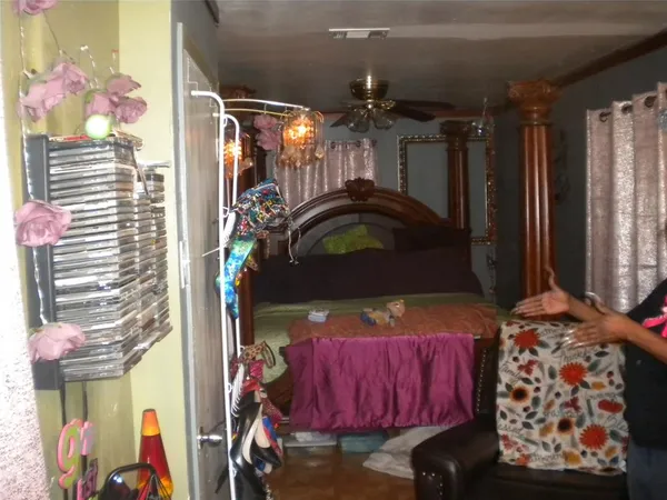 a bedroom with a bed and a mirror