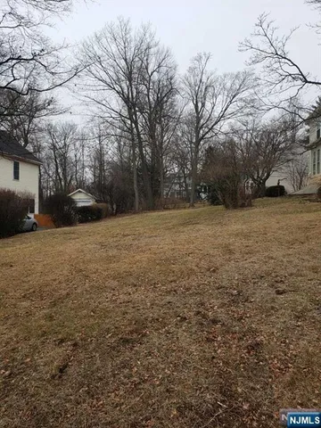 a view of a field with trees in front of it