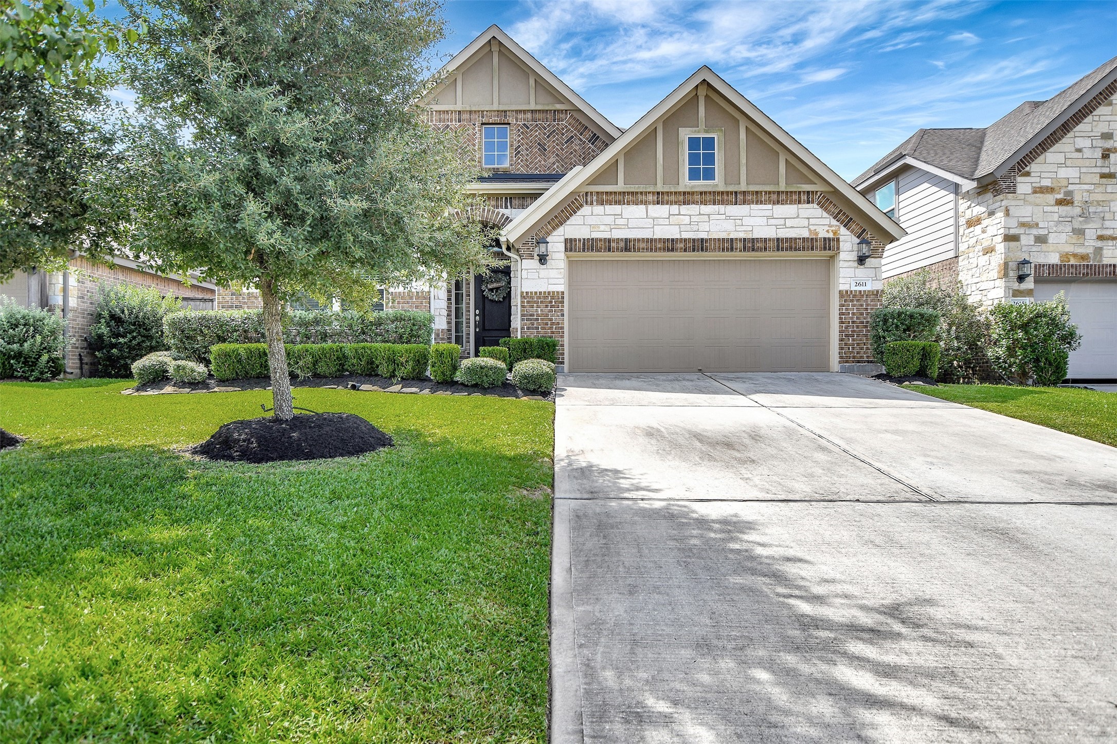 a front view of a house with a yard and garage