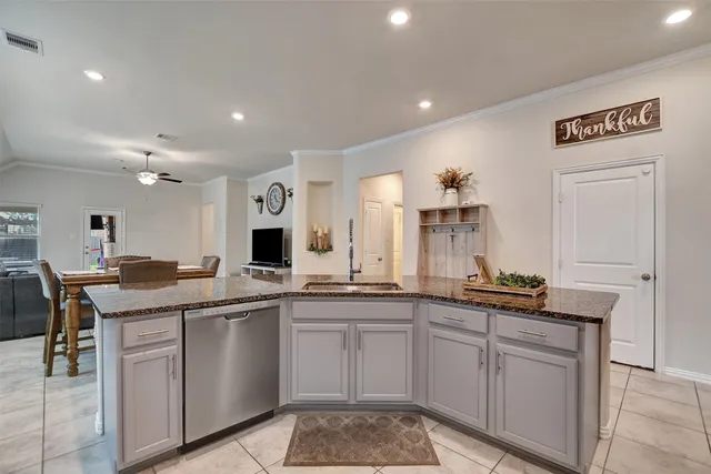 a kitchen with sink and cabinets