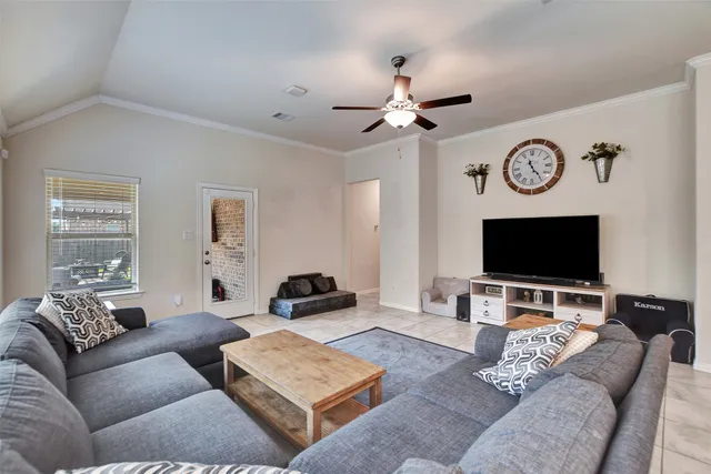 a living room with furniture and a flat screen tv