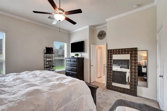 a bedroom with a bed and a television