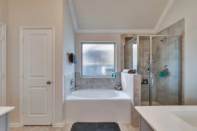 a bathroom with a tub and shower