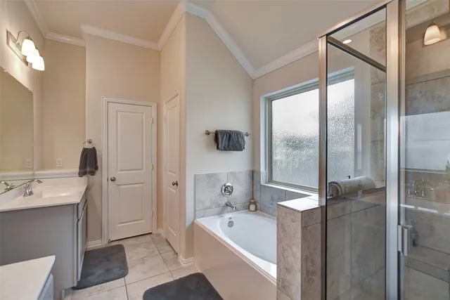 a bathroom with a tub sink and mirror